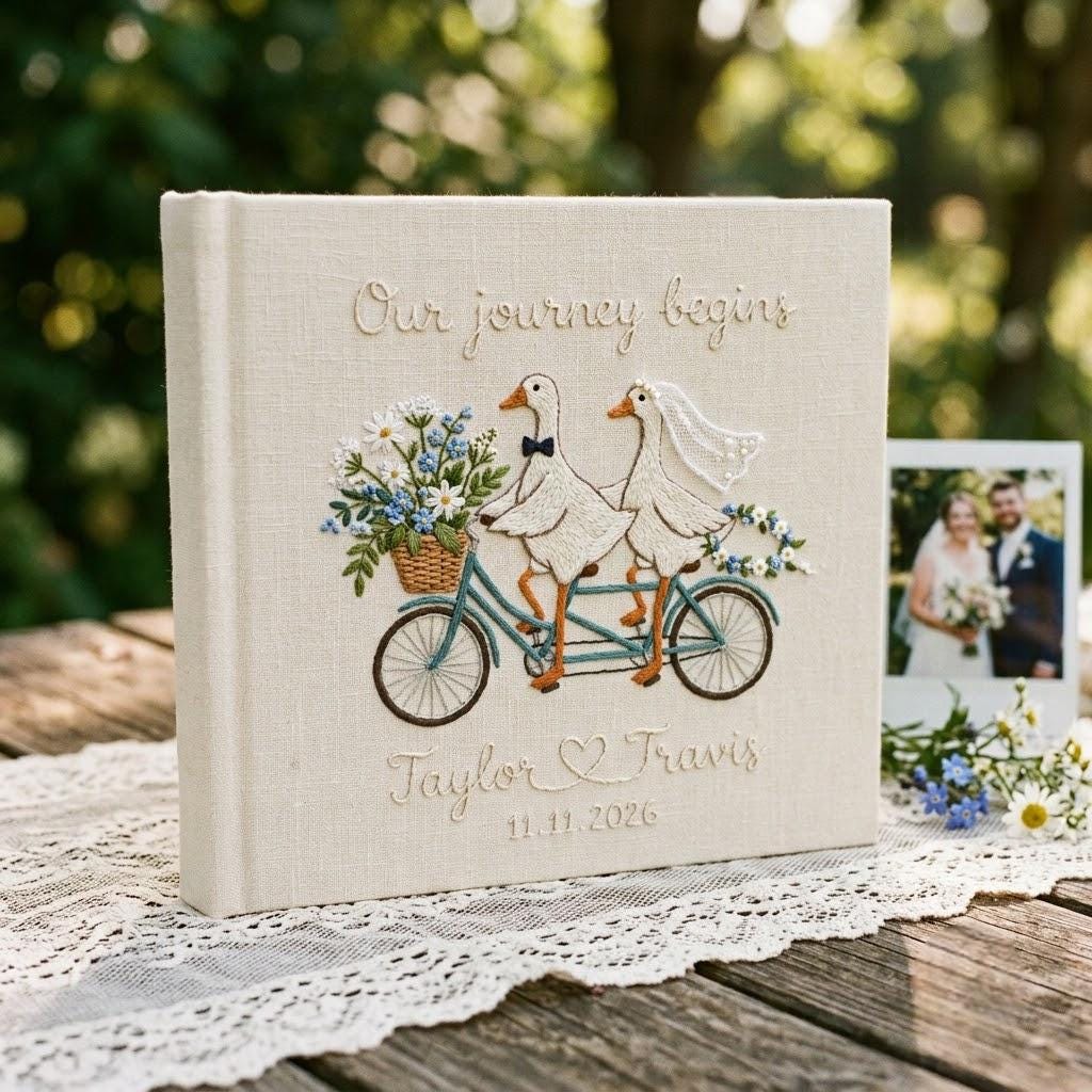 Natural linen guest book, portrait, two geese on a tandem bicycle with wildflowers, Our journey begins, names, date