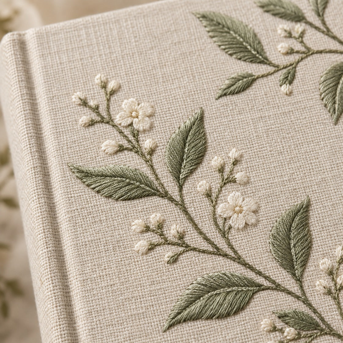 Close view of botanical embroidery and linen texture